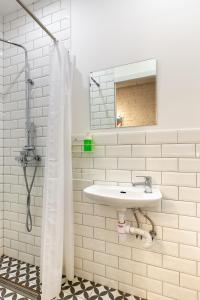 a white bathroom with a sink and a mirror at Axel Hotel Moscow in Moscow