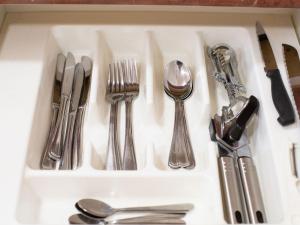 a drawer filled with silver utensils on a counter at Bella Vista Motel New Plymouth in New Plymouth