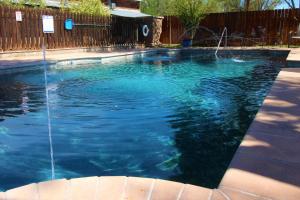 a swimming pool with a water fountain at The Hotel Limpia in Fort Davis