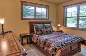 a bedroom with a bed and two windows at 120 Rachel Lane in Breckenridge