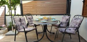 a table and chairs on a patio at House Marija island Krk in Punat