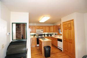 a kitchen with wooden cabinets and white appliances at 72 Clubhouse in Breckenridge