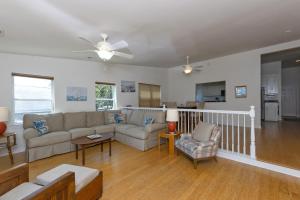 a living room with a couch and a table at Harbor Delight On The Bay - Private Sandy Beach! Home in Norfolk