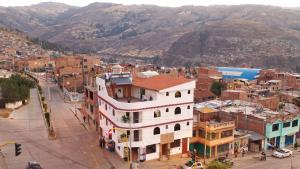an overhead view of a city with mountains in the background at Atusparia Guest House Huaraz in Huaraz