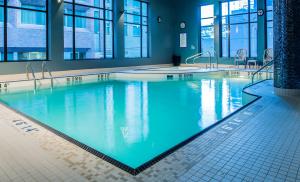 a large swimming pool with blue water in a building at Hotel BLU in Vancouver