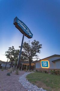 a street sign in front of a building at Stonewall Motor Lodge in Stonewall