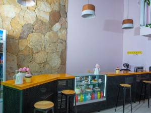 a kitchen with a counter and stools in a room at Casana Hotel in Cúcuta