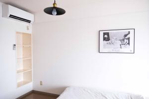 En eller flere senger på et rom på MINIMAL SHIMOKITA Stylish Loft or Studio Apt
