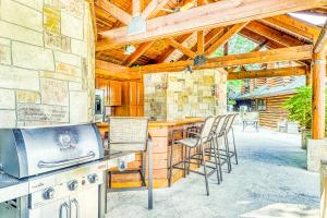 a kitchen with a bar with stools and a stove at Golf View Condo in Pigeon Forge