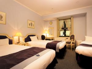 Postel nebo postele na pokoji v ubytování Hotel Monterey Osaka