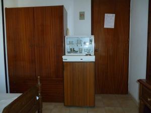 una pequeña cocina con microondas en una habitación en Pension Eleni Rooms, en Kokkari