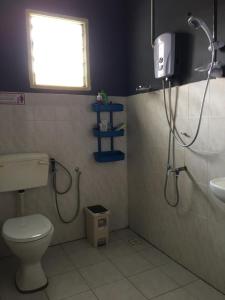 a bathroom with a shower and a toilet and a sink at Suhana HomeStay Semporna - Cozy Home in Semporna +31 photos