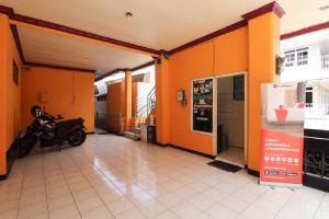 an orange building with a motorcycle parked in it at RedDoorz near Sarangan Lake in Magetan