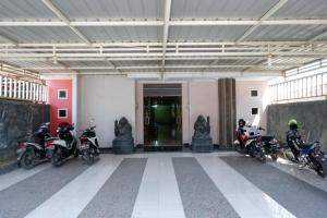 a group of motorcycles parked in a building at RedDoorz near GOR Wisanggeni in Tegal