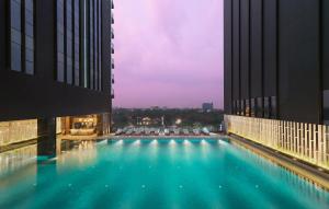 a large swimming pool on the side of a building at Kantharyar Serviced Apartment in Yangon