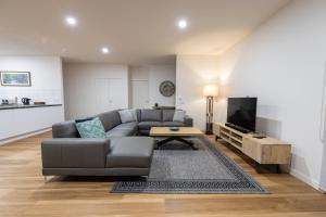 a living room with a couch and a tv at All Seasons Marysville in Marysville