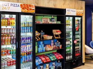 a store with two refrigerators with drinks and food at Ibis Budget Portsmouth in Portsmouth