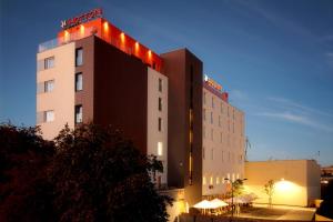 a building with lights on the top of it at Hotton Hotel in Gdynia