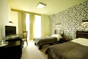 Postel nebo postele na pokoji v ubytování Hotton Hotel