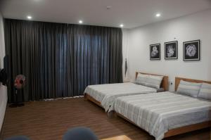 Postel nebo postele na pokoji v ubytování Nếp Apartment Hotel
