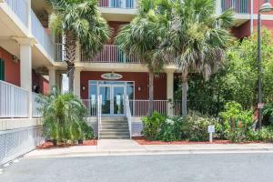 a building with palm trees in front of it at Water Street Hotel & Marina, Ascend Hotel Collection in Apalachicola