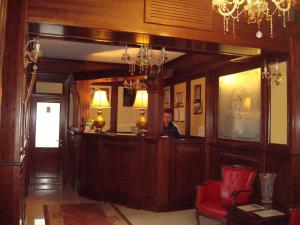 a man sitting at a bar in a room at Pensiunea Carmen Silvae in Gura Humorului