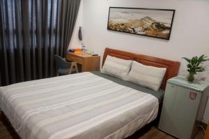 Postel nebo postele na pokoji v ubytování Nếp Apartment Hotel