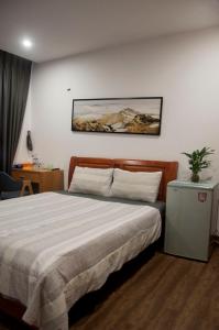 Postel nebo postele na pokoji v ubytování Nếp Apartment Hotel