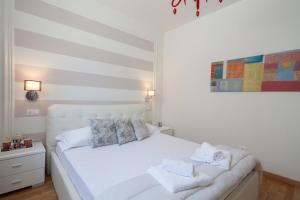 a bedroom with a white bed with towels on it at LEO'S HOME in La Spezia