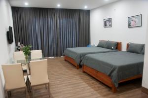 Postel nebo postele na pokoji v ubytování Nếp Apartment Hotel