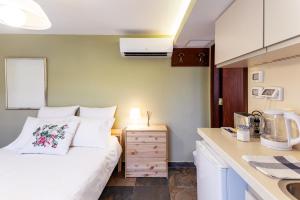 a small bedroom with a bed and a kitchen at Quiet Apartments in Beit Safafa- Jerusalem in Jerusalem +4 photos