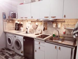 a kitchen with a washing machine and a sink at PIJAMA HOUSE - Bike & Bed in Plovdiv