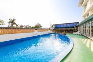 a large swimming pool on the side of a building at Hotel Miyahira  in Ishigaki Island