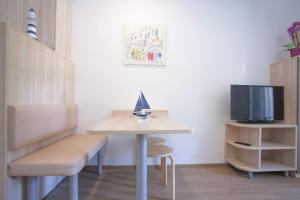 a small room with a table and a tv at Studio apartment - seaview in Premantura