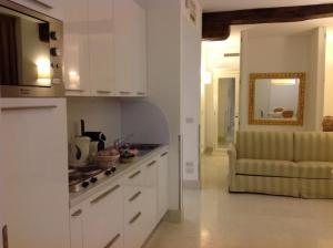 a kitchen with white cabinets and a couch in a room at Al Redentore Di Venezia in Venice +93 photos