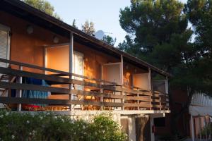 a house with wooden balconies on the side of it at Studio apartment - seaview in Premantura