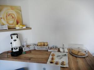 a table with a flower on a shelf with donuts at Residenza Skanderbeg in Montecilfone