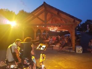 a group of people at a party under a tent at Camping la Plage Lot Vallée de la Dordogne Rocamadour in Meyronne