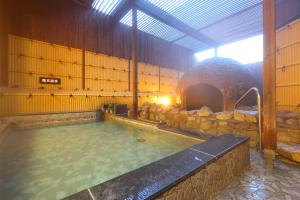 a large pool of water in a building at Route Inn Grantia Dazaifu in Dazaifu