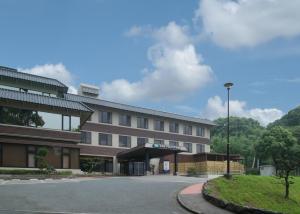 a building with a parking lot in front of it at Route Inn Grantia Dazaifu in Dazaifu