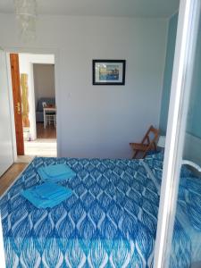 a bedroom with a bed with a blue comforter at Apartments Relax Punat in Punat