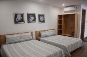 Postel nebo postele na pokoji v ubytování Nếp Apartment Hotel