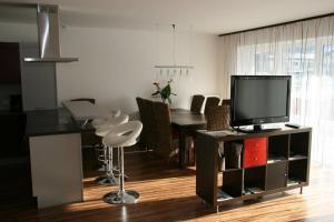 a kitchen and dining room with a television and a table at Appartement Crystal by Schladmingurlaub in Schladming