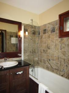 a bathroom with a tub and a sink and a shower at 151 Manoir Savoie - ARC 1950 in Arc 1950