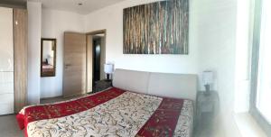 a bedroom with a bed with a red and white blanket at Villa Antunovic in Malinska +32 photos