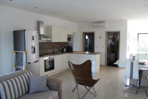 a living room with a couch and a kitchen at Villa Antunovic in Malinska