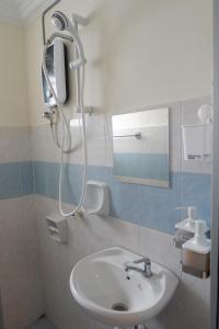 a bathroom with a sink and a shower at Permai Seri Homestay in Ampang