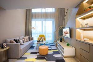 a living room with a couch and a table at Citadines Keqiao Shaoxing in Shaoxing