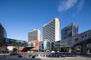 a group of tall buildings in a city at Citadines Keqiao Shaoxing in Shaoxing