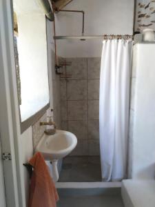 a bathroom with a sink and a shower curtain at Off Beat Safaris Bush Lodge in Hoedspruit